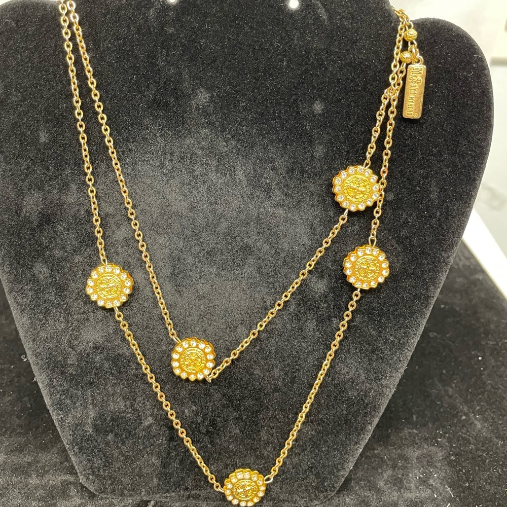 Gold-ton, layered chain necklace wth medallions & crystal accents.